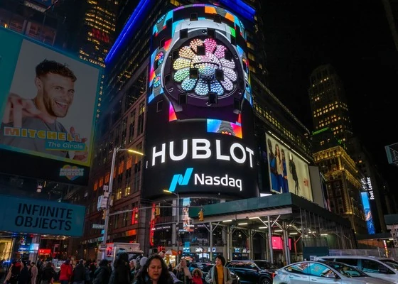 The curved Nasdaq screen and surrounding city lights in Times Square